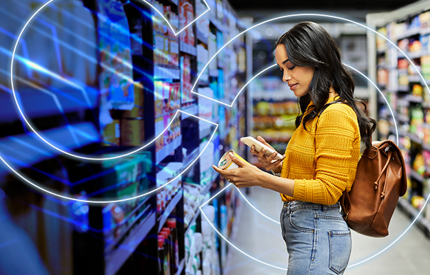 Shopper reading food packaging while holding two items in a grocery store