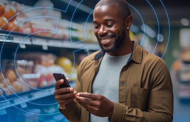 Man Looking at Phone in Grocery Store Produce Section